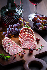 Image showing Saltufo - Italian salami delicacy, salami with summer truffle coated with Parmesan cheese with red wine and grapes