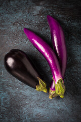 Image showing Assortment of fresh aubergines on dark background