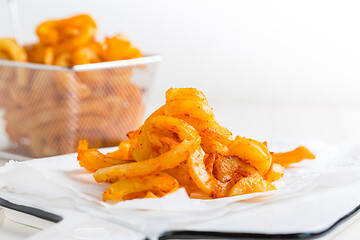 Image showing Spicy seasoned curly fries. Ready to eat.