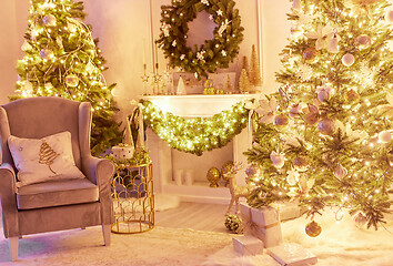 Image showing Beautiful Christmas interior decoration for family celebration with pine tree, armchair, fireplace