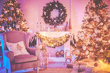 Image showing Beautiful Christmas interior decoration for family celebration with pine tree, armchair, fireplace