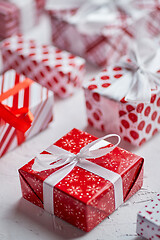 Image showing Christmas concept. Close up on festive paper wrapped gifts with ribbon