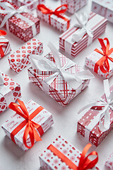 Image showing Colorful white and red Christmas theme. Wrapped gifts in festive paper with ribbon