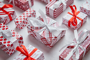 Image showing Colorful white and red Christmas theme. Wrapped gifts in festive paper with ribbon