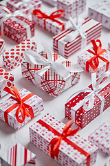 Image showing Colorful white and red Christmas theme. Wrapped gifts in festive paper with ribbon