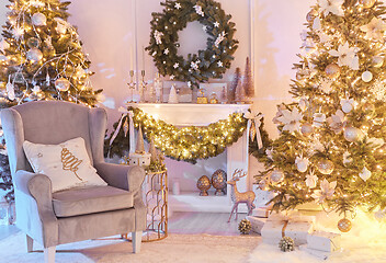 Image showing Christmas interior concept. With fireplace, armchair, pine tree, wrapped gifts, lights