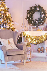 Image showing Beautiful Christmas interior decoration for family celebration with pine tree, armchair, fireplace