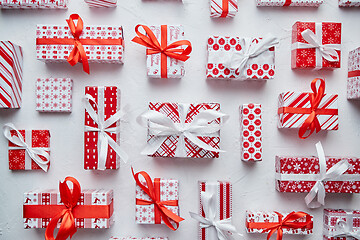 Image showing Various pattern and size Christmas boxes placed on white background. Wrapped in festive paper