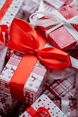 Image showing Christmas concept. Close up on festive paper wrapped gifts with ribbon