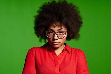 Image showing Discontent serious young African-American girl in glasses and red shirt