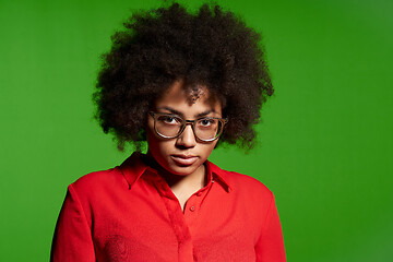 Image showing Discontent serious young African-American girl in glasses and red shirt