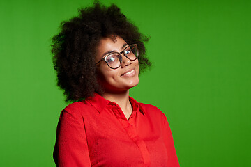 Image showing Smiling young African-American girl in glasses and red shirt looking at camera