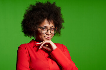 Image showing Smiling young African-American girl in glasses and red shirt looking at camera