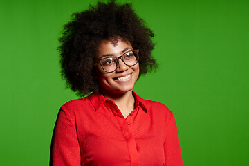 Image showing Smiling young African-American girl in glasses and red shirt looking at camera