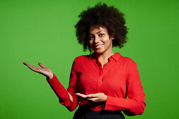 Image showing Smiling young African-American girl in glasses and red shirt looking at camera