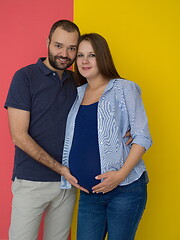 Image showing pregnant couple  isolated over colorful background