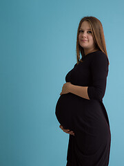 Image showing Portrait of pregnant woman over blue background