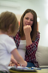 Image showing daughter painting nails to her pregnant mom