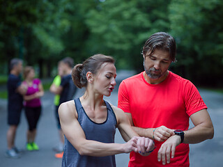 Image showing sporty couple using smart watches