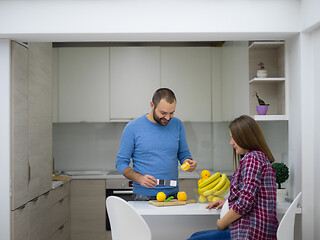 Image showing couple cooking food fruit lemon juice at kitchen