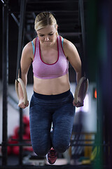 Image showing woman working out pull ups with gymnastic rings