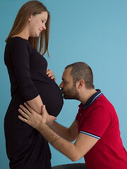 Image showing pregnant couple  isolated over blue background