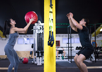 Image showing young athletes couple working out with medical ball