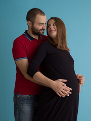 Image showing pregnant couple  isolated over blue background