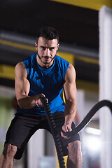 Image showing athlete man doing battle ropes cross fitness exercise