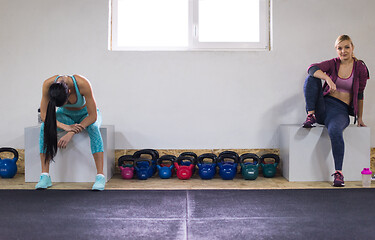 Image showing young athletes women sitting and relaxing