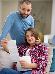 Image showing pregnant couple looking baby\'s ultrasound