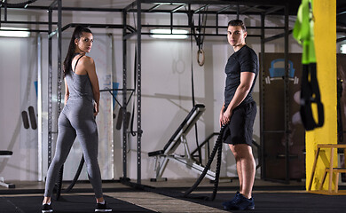 Image showing sports couple doing battle ropes cross fitness exercise