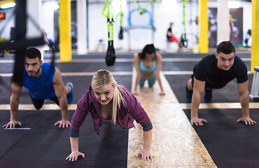 Image showing young healthy people doing pushups