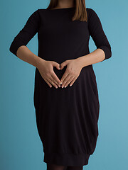 Image showing Portrait of pregnant woman over blue background