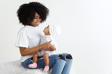 Image showing Portrait of beautiful african woman holding on hands her little baby