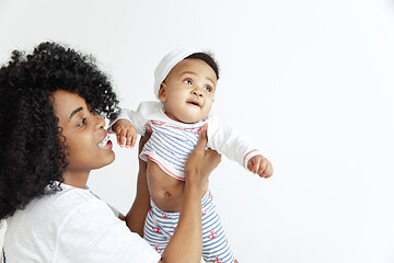 Image showing Portrait of beautiful african woman holding on hands her little baby