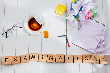 Image showing Stationery and word EXAMINATIONS made of letters on wooden background