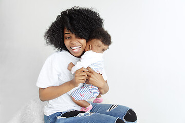 Image showing Portrait of beautiful african woman holding on hands her little baby