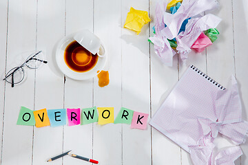 Image showing OVERWORK. Message in wooden cubes on a desk background.