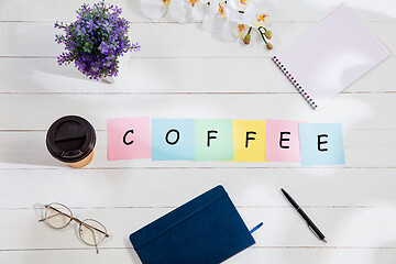 Image showing COFFEE. Message at colorful note papers on a desk background.