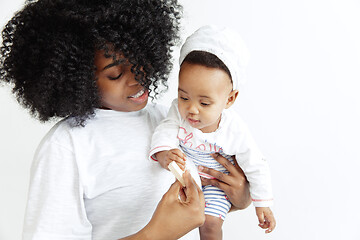 Image showing Portrait of beautiful african woman holding on hands her little baby