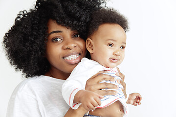 Image showing Portrait of beautiful african woman holding on hands her little baby