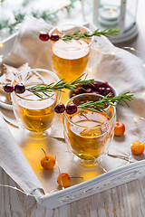 Image showing Christmas apple cider cocktail with cranberries and rosemary