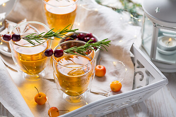 Image showing Christmas apple cider cocktail with cranberries and rosemary