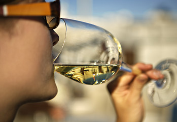 Image showing Woman sipping a glass of white wine