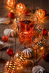 Image showing Spicy winter tea or punch with anise and meringue pastry