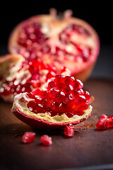 Image showing Fresh organic pomegranate on wooding cutting board