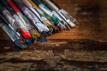 Image showing Artist vintage paint brushes on wooden background