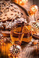 Image showing Apple mulled wine with Christmas Stollen. Traditional Sweet Fruit Loaf with icing sugar.  