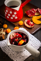 Image showing Hot spicy mulled wine with fruits and spices in mug